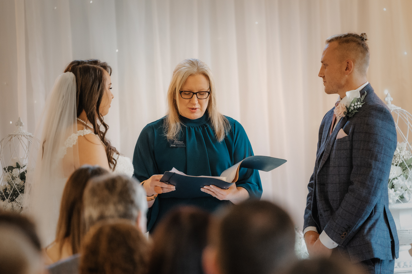 Deb Reed Celebrant Essex Colchester officiating Rachael and Lukes wedding, smiling at their son.